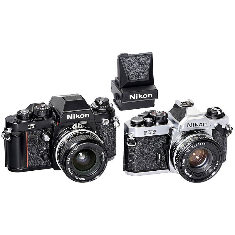 Nikon F3 and FM2: Nikon F3 and FM2 Nikon, Japan. 1) Nikon F3, 1980, no. 1357642, prism-finder and waist-level viewfinder DW-3. With Nikkor 2,8/24 mm AI. (2-3/2) - And: 2) Nikon FM2, 1983, no. 7063975, chrome, with Nikk