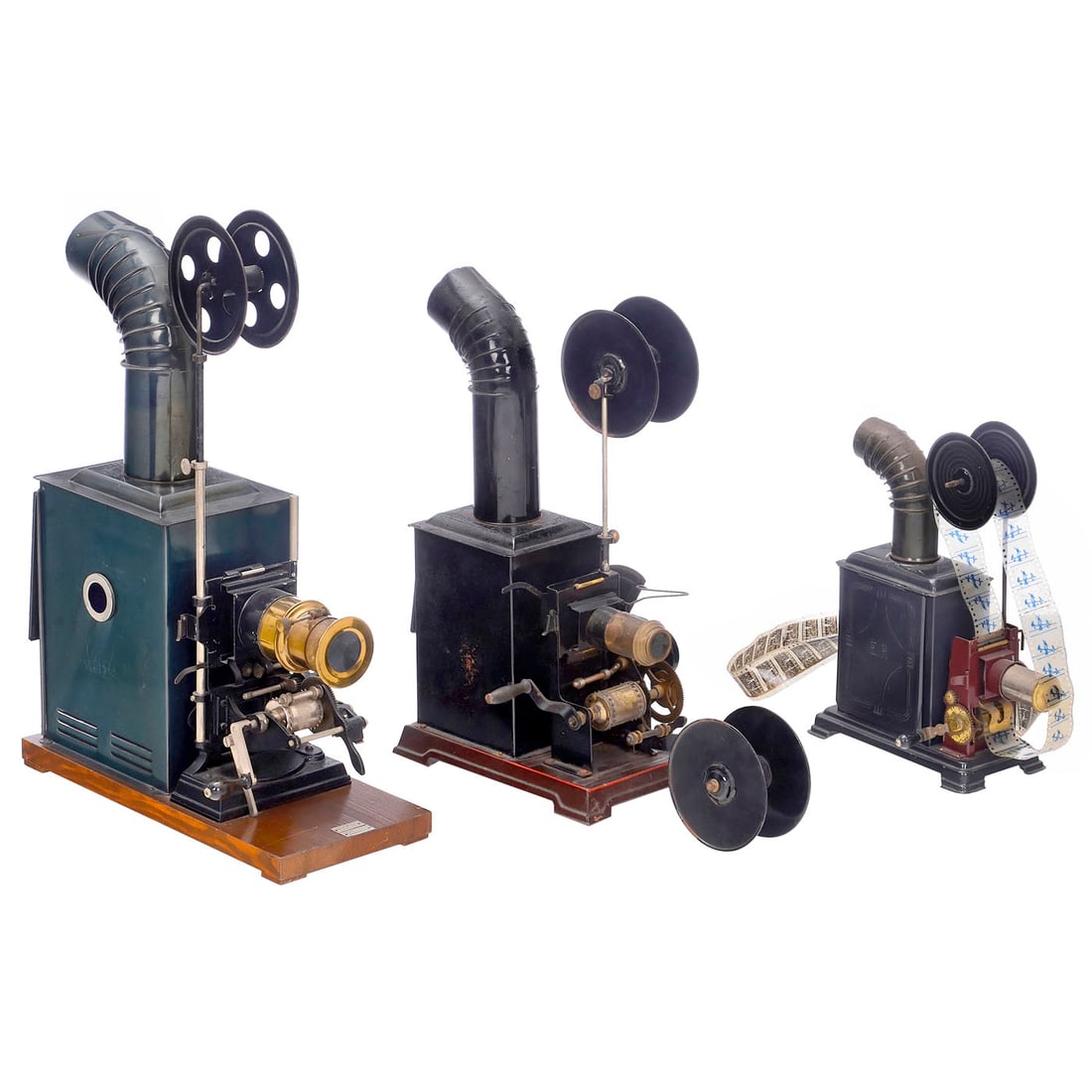 3 Cinematographs: 3 Cinematographs All for 35mm film, all drives working. 1) Bing, Nuremberg. Cinematograph and magic lantern, beautiful device on a wooden base, brass finish, beater mechanism, and equipped for 6 cm wi