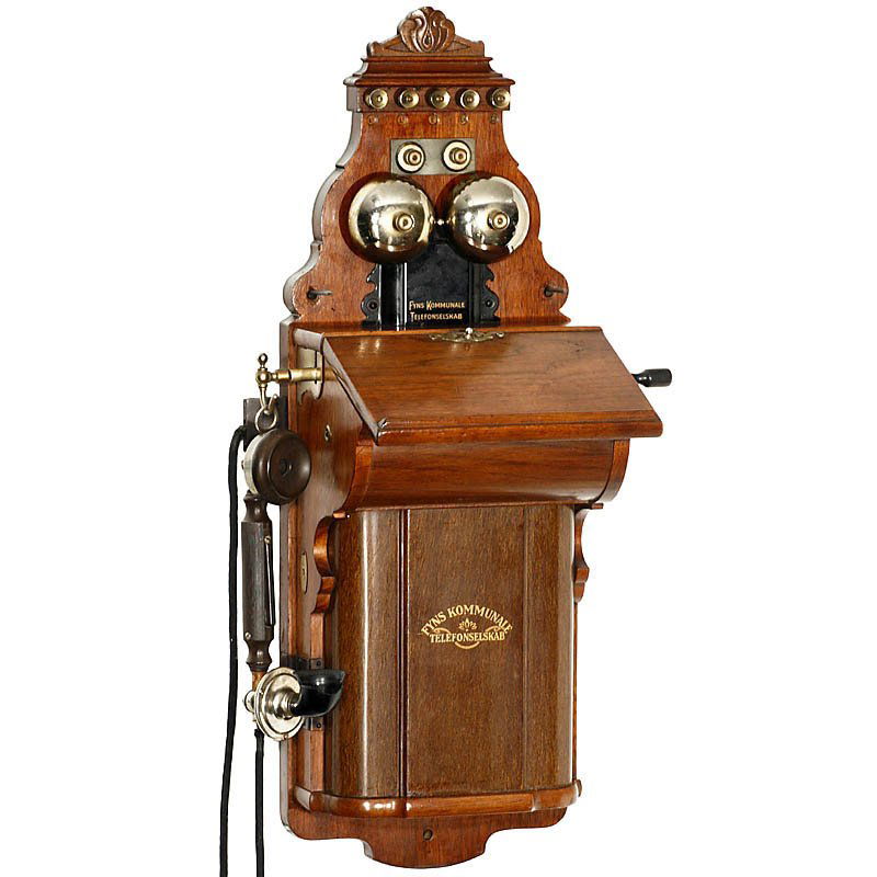 Wall Telephone by "L.M. Ericsson" Model AB 520, from 19: Wall Telephone by "L.M. Ericsson" Model AB 520, from 1905 With writing slope, metal battery lid, original handset, horn defective, manufactured for the Danish phone company "Fyns Kommunale Telefonsels