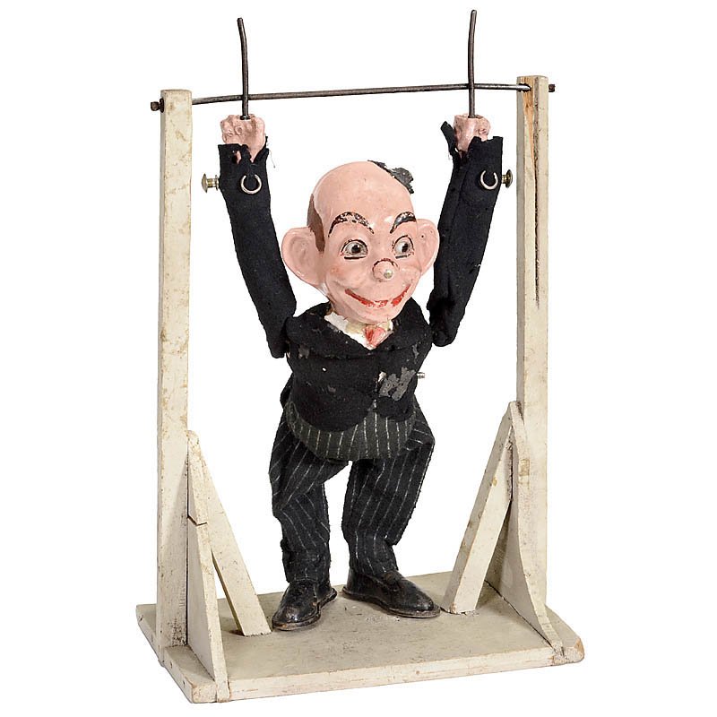 Clockwork Acrobat Toy, c. 1930: Clockwork Acrobat Toy, c. 1930 With composition head, brown glass eyes, articulated shoulders, original felt costume (worn) and key-wind mechanism in torso causing figure to rotate, on white-painted w