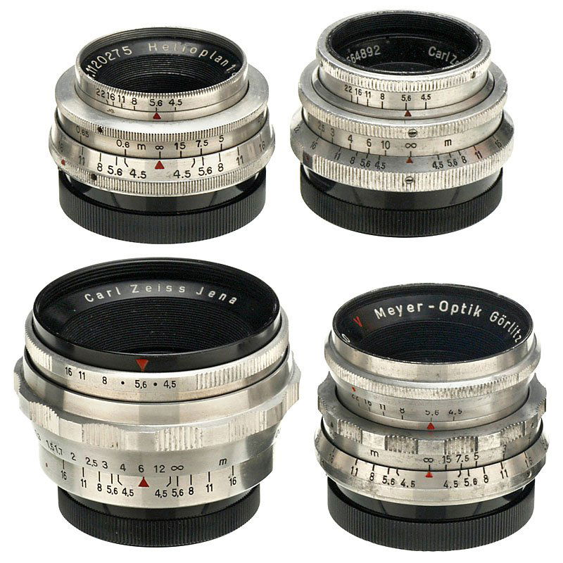 4 Exakta Lenses "40 mm" (Various): 4 Exakta Lenses "40 mm" (Various) Carl Zeiss Jena. 1) Tessar 4,5/40 mm T, no. 3564892, 2 caps. (3-/3+) – 2) Tessar 4,5/40 mm T, no. 3829026, 2 caps. (3+/2–3) – Meyer Görlitz. 3) Helioplan 4,5/4