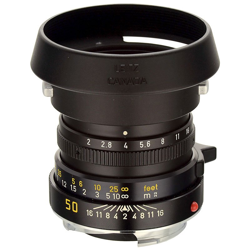 Leitz Summicron-M 2/50, 1988: Leitz Summicron-M 2/50, 1988 Leitz, Wetzlar, no. 3471818, recomputed six-element lens in a lightweight design, scooped focus lever, never used. With front lens cap, lens hood 12538, soft-leather case,