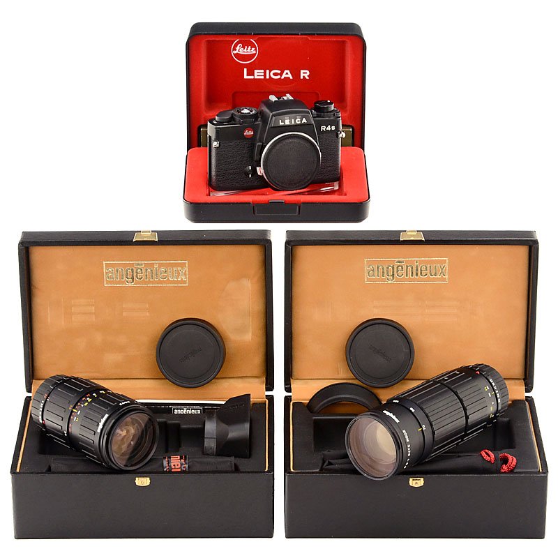 Leica R4s and 2 Angenieux Zoom Lenses, 1984: Leica R4s and 2 Angenieux Zoom Lenses, 1984 Leitz, Wetzlar. R4s-MOD. 2, no. 1656079, like new, with inner and outer box and paperwork. with 2 Angenieux zoom lenses 2,5–3,3/35–70 mm and 3,5/70–21