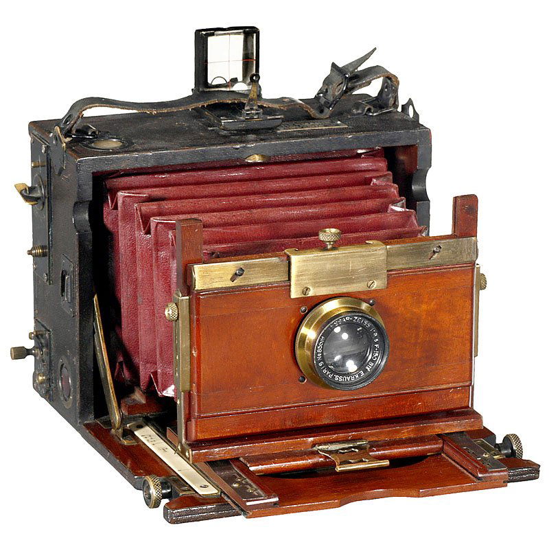 Folding-Bed Camera by Hermagis, c. 1910: Folding-Bed Camera by Hermagis, c. 1910 Hermagis, Paris. Plate size 3 ½ x 4 ½ in., polished wood, leather-covered, focal plane shutter (stuck, but complete), with Zeiss/Krauss Tessar 6,3/150 mm, no.