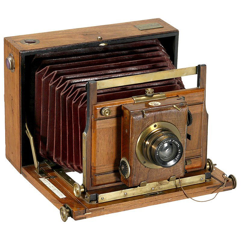 Folding-Bed Camera "Mendel", c. 1890: Folding-Bed Camera "Mendel", c. 1890 "Appareils Photographiques, Charles Mendel, Paris, 188 & 188bis Rue d'Assas". Plate size 5 x 7 in., polished wood with brass trim, dark-red bellows, lens "Stigmat
