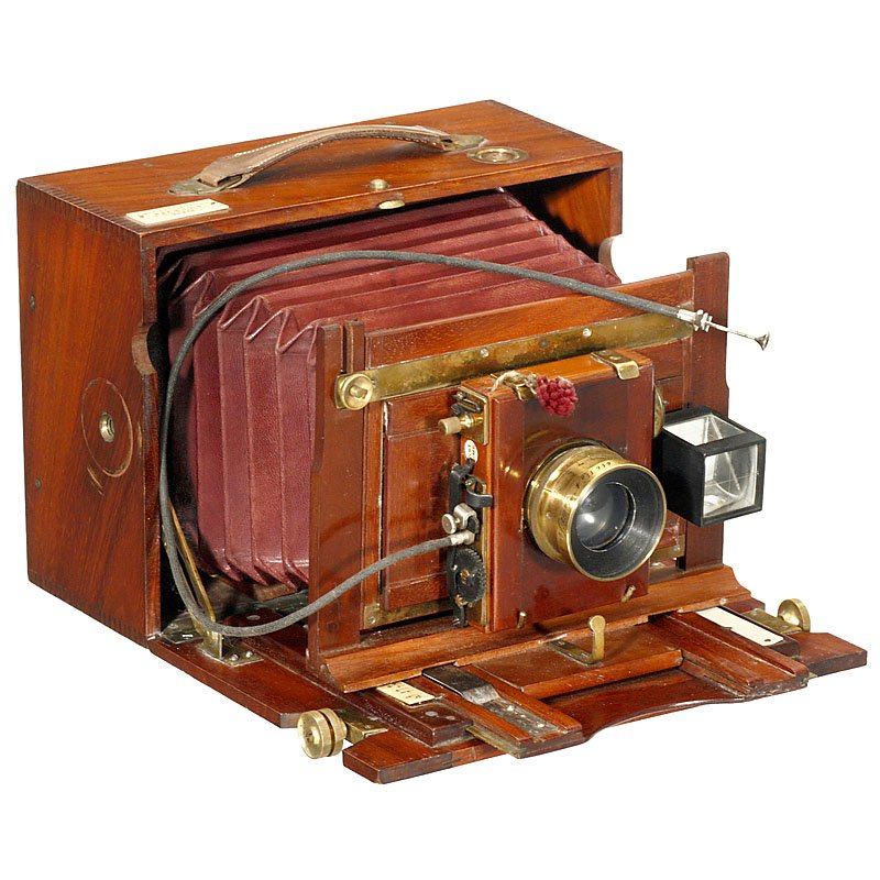 Folding-Bed Camera "Hermagis", c. 1900: Folding-Bed Camera "Hermagis", c. 1900 Hermagis, 18, Rue Rambuteau Paris. Plate size 5 x 7 in., tropical wood with brass trim, dark-red bellows, with viewfinder, lens: Hermagis "Aplanastigmat 1:7 F=21