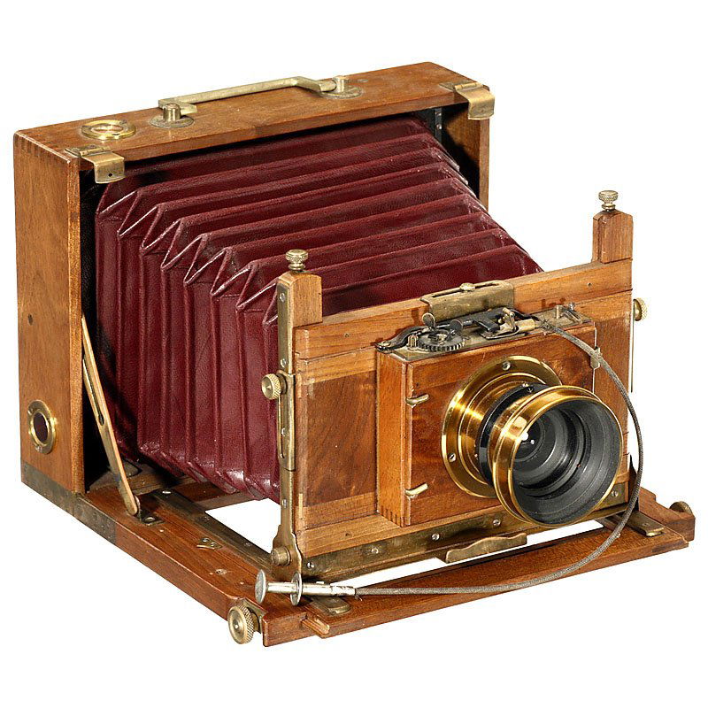 French Folding Camera, c. 1885–95: French Folding Camera, c. 1885–95 Unmarked, plate size 5 x 7 in., tropical wood with brass trim, dark-red bellows, focusing screen back. – Rare brass lens by A. Banz, Opticien F.nt, Paris. "Rapide