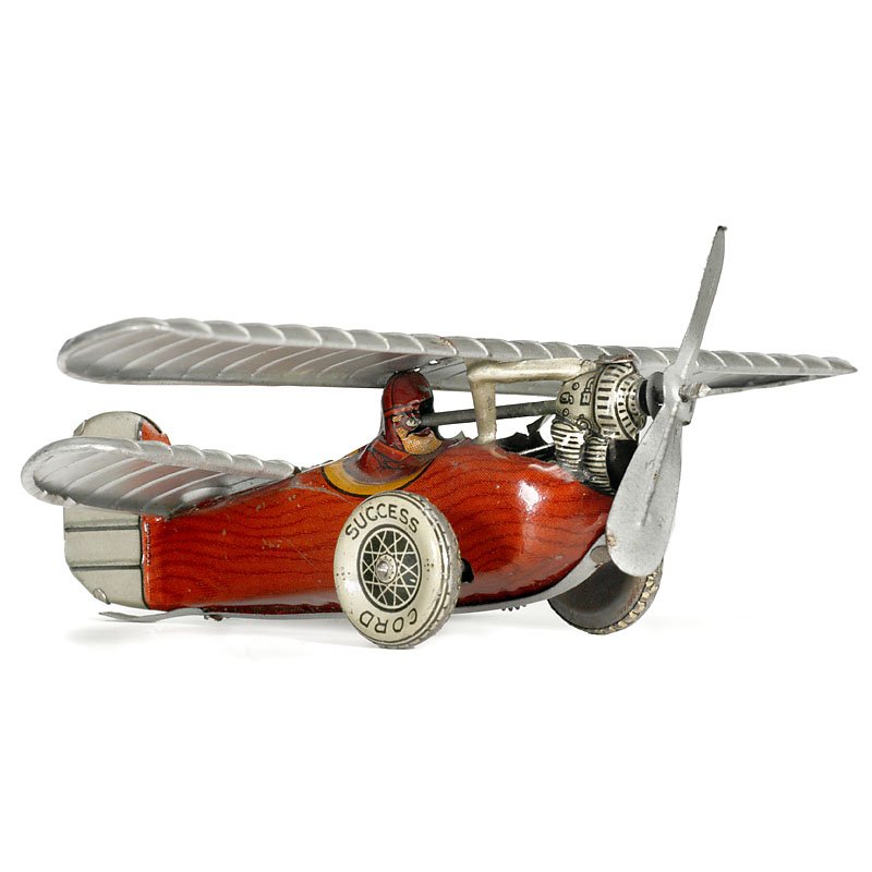 Tin Toy Aeroplane by Saalheimer & Strauss, c. 1935: Tin Toy Aeroplane by Saalheimer & Strauss, c. 1935 Nuremberg, model of the "Mignet HM 14", lithographed tin, with pilot figure, clockwork (working), length: 4 ¾ in. A rare model. Blechspielzeug-Flug