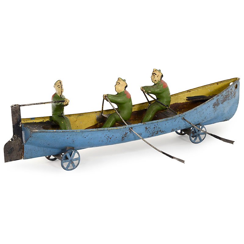 Rowboat with Helmsman, c. 1895: Rowboat with Helmsman, c. 1895 Germany, unmarked, hand-painted tin, spoked wheels, length 11 ¾ in. Ruderboot mit Steuermann, um 1895 Deutschland, unbezeichnet, handlackiertes Blech, Speichenräder, L