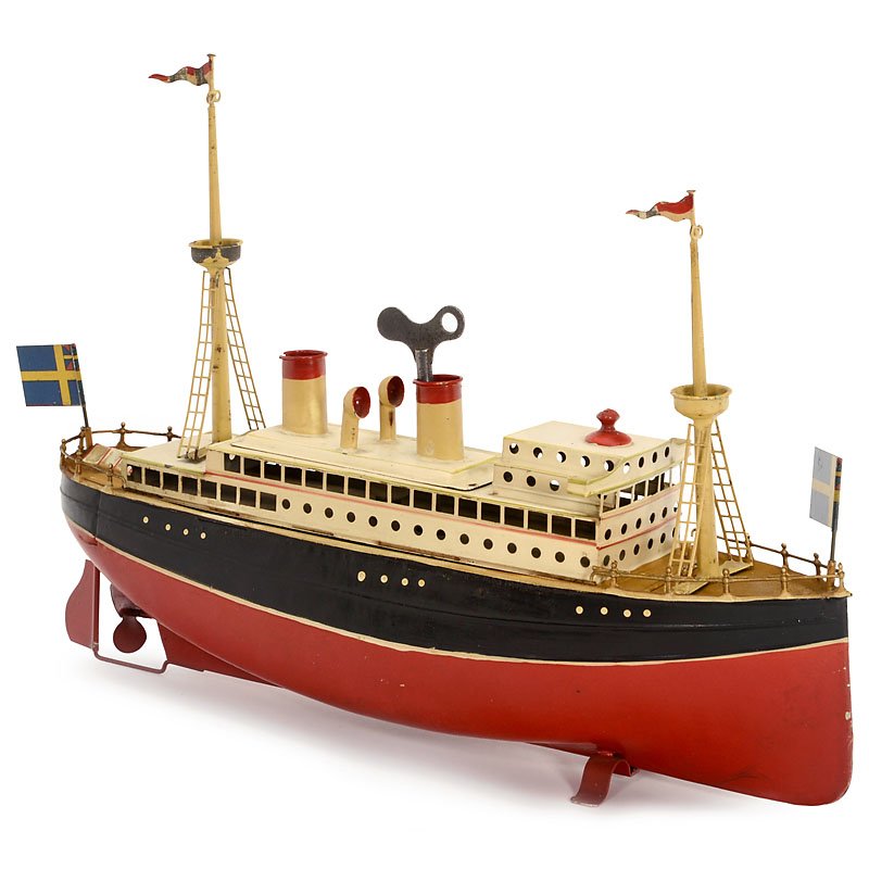 Carette Passenger Steamer, c. 1920: Carette Passenger Steamer, c. 1920 Hand-japanned tin (all original), 4 flags (the Swedish one added), clockwork (working), length 13 in. Excellent original condition. Carette-Passagierdampfer, um 1920