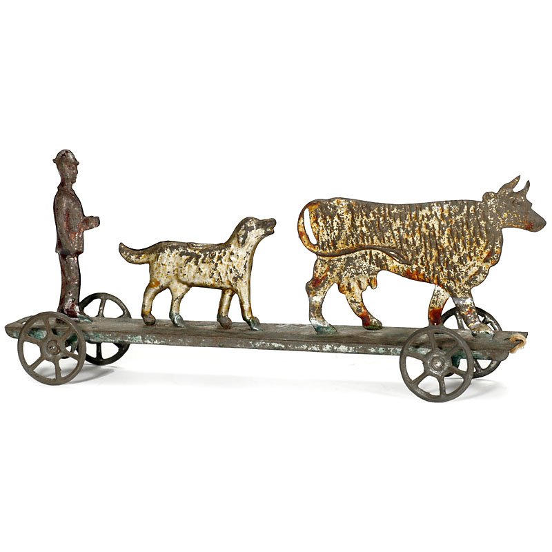 Penny Toy Carriage, c. 1890: Penny Toy Carriage, c. 1890 With cow, dog and farmer; hand-painted tin, length 7 ½ in. Penny Toy Fahrgestell, um 1890 Mit Kuh, Hund und Bauer; handbemaltes Blech, Länge 19 cm.