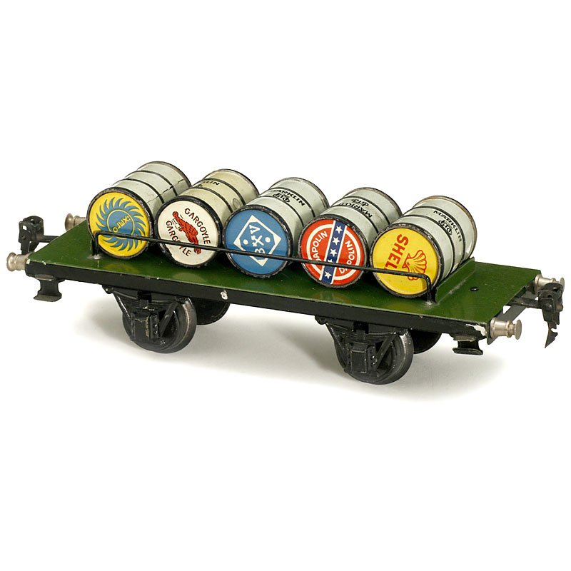 Märklin Stage Truck with Petrol Barrels No. 1999/1,: Märklin Stage Truck with Petrol Barrels No. 1999/1, Gauge I, c. 1930 Hand-japanned tin, with 5 removable barrels, length 9 ¾ in. Very good condition. Plattformwagen mit Benzinfässern "Märklin" Nr