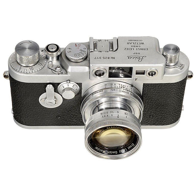 Leica IIIg with Summicron, 1957: Leica IIIg with Summicron, 1957 Leitz, Wetzlar. No. 825317 (early IIIg, started with serial no. 825001), body in excellent condition. With Summicron 2/5 cm, no. 1040495, with minor cement loss, everyt