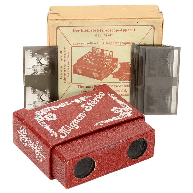 Mignon-Stéreo: "The Smallest Stereoscopical Apparatus: Mignon-Stéreo: "The Smallest Stereoscopical Apparatus of the World", c. 1935 "Made in Germany. Small viewer, dark-red leather covering, for stereo slides 30 x 62 mm, with original box and 6 "Mignon" 