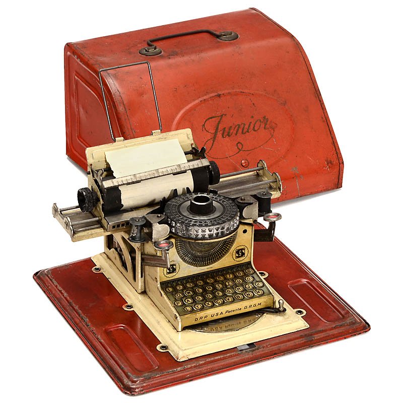 Junior Gescha Tin Toy Typewriter, 1930: Junior Gescha Tin Toy Typewriter, 1930 Manufacturer: "Gebrüder Schmidit, Nuremberg", daisy-wheel typewriter, complete with tin cover. Spielzeug-Schreibmaschine "Junior Gescha", 1930 Deutsche Typenrad