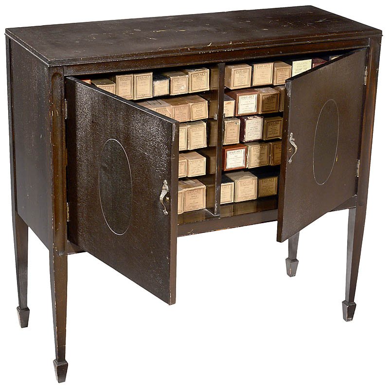Music Roll Cabinet with 66 Duo Art Rolls, c. 1920: Music Roll Cabinet with 66 Duo Art Rolls, c. 1920 Mahogany cabinet with 10 compartments, size 40 ½ x 15 ¾ x 38 in., with 66 reproducing piano rolls. Notenrollenschrank mit 66 Duo-Art-Rollen, um 19