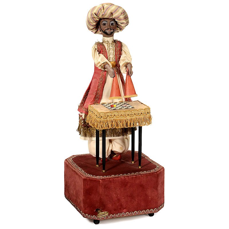 Musical Magician Automaton by Reuge, Switzerland, 20th: Musical Magician Automaton by Reuge, Switzerland, 20th Century Modeled as an Arabian man, holding two cups that he raises and lowers to reveal a series of four changing items which appear and disappea