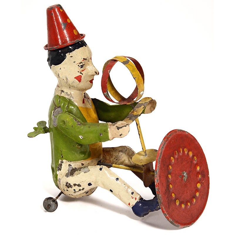 Günthermann Tin Toy Figure "Turning Clown", c. 1910: Günthermann Tin Toy Figure "Turning Clown", c. 1910 Clockwork-driven circus clown, hand-painted tin, with spinning wheel and ball, height 6 ¼ in., working. Günthermann-Figur "Drehender Clown", um