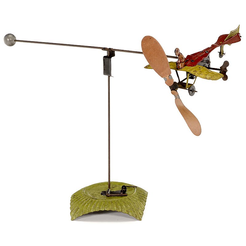 The Stunt Flyer by Johann Distler No. 338W, c. 1935: The Stunt Flyer by Johann Distler No. 338W, c. 1935 Hand-painted tin, lithographed figure, clockwork (working), length of the plane 6 ¼ in., rare! Sturzflieger von "Johann Distler" Nr. 338W, um 1935
