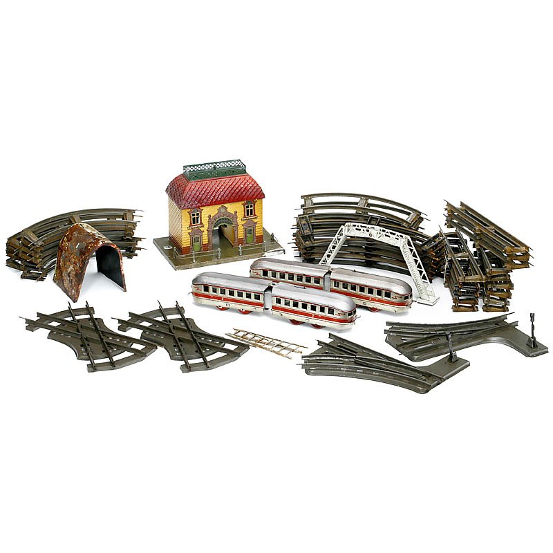 Lot of Gauge 0 Toy Trains: Lot of Gauge 0 Toy Trains 1) Station building by Gebrüder Bing, embossed tin, 9 7/8 x 6 ¼ x 7 4/5 in., c. 1920. – 2) 2 railcars by Johann Distler, made in U.S. zone, Germany, tin, clockwork (work