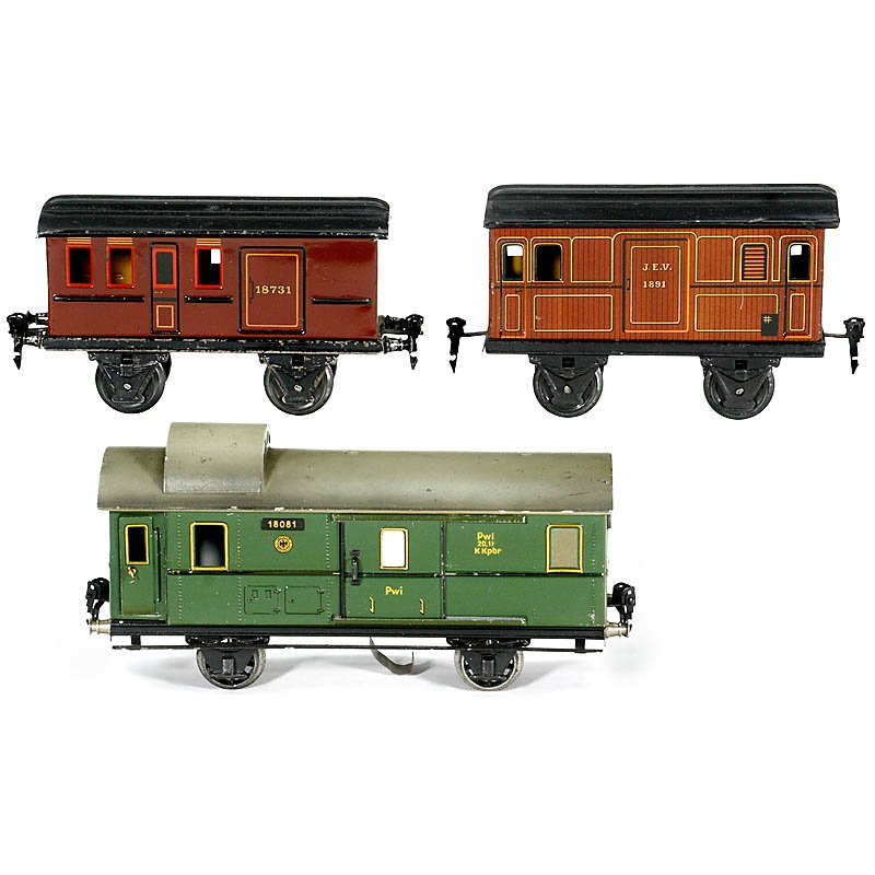 Märklin Lithographed Tin Luggage Car and 2 additional: Märklin Lithographed Tin Luggage Car and 2 additional Wagons, c. 1935 1) Luggage car no. 1808/1, length 11 in., with electric light. – 2) Passenger car no. 1873/1, length 8 ¼ in. – And: 3) Passe