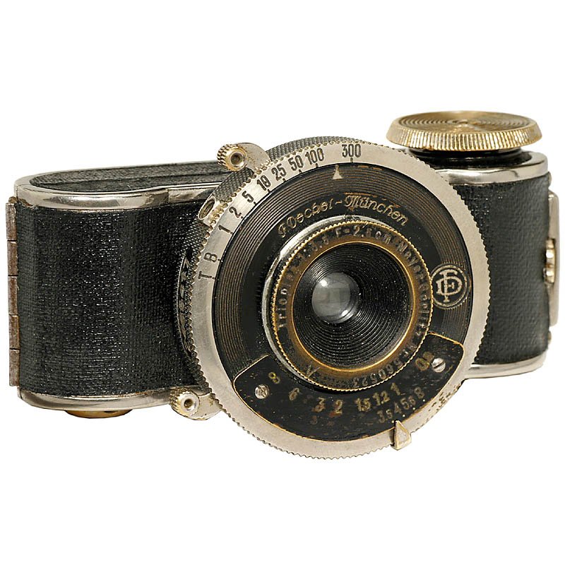 Mini-Fex, 1932: Mini-Fex, 1932 Foto-Fex/Fritz Kaftanski, Berlin. Subminiature camera with "large" Compur-00 shutter, Meyer Görlitz Trioplan 3,5/2,5 cm. Finder missing. Mini-Fex, 1932 Foto-Fex/Fritz Kaftanski, Berlin