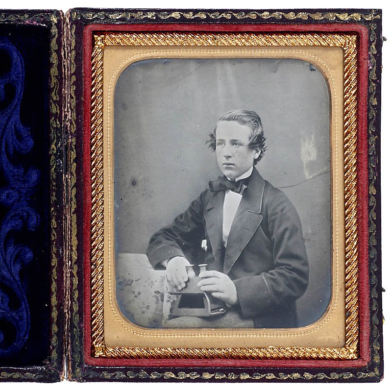 Ambrotype: Boy with Stereo Viewer, c. 1856: Ambrotype: Boy with Stereo Viewer, c. 1856 England. 1/6 plate, boy with early stereo viewer, hand-colored, brass passe-partout, with case (top loose). Ambrotypie: Junge mit Stereobetrachter, um 1856 E