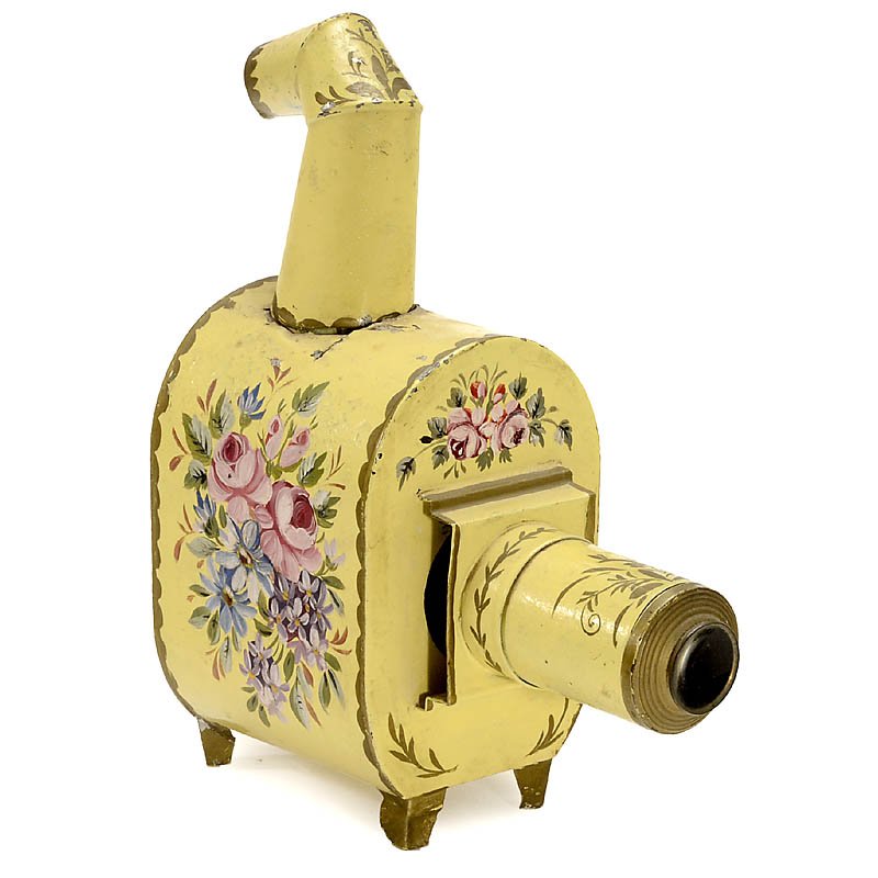 Small Hand-Painted Magic Lantern, c. 1900: Small Hand-Painted Magic Lantern, c. 1900 Probably Bing, Nuremberg. For 2 ¾ in. slides, with painted floral decoration, height 9 ¾ in. (25 cm), some splits and losses. Without burner. Attractively d