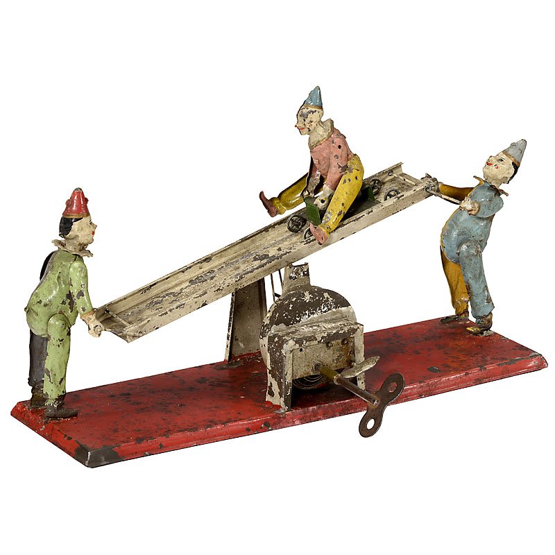 Clown See-Saw Musical Clockwork Toy by Günthermann, c.: Clown See-Saw Musical Clockwork Toy by Günthermann, c. 1910 Fürth, hand-painted tin toy depicting two articulated clowns raising and lowering a see-saw so that their companion rolls back and forth o