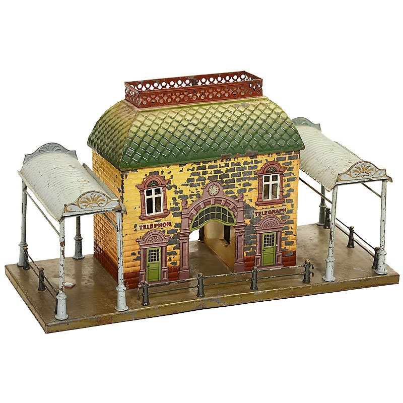Bing Railway Station No. 7063, c. 1915: Bing Railway Station No. 7063, c. 1915 Gebrüder Bing, Nuremberg; embossed tin, fine realistic painting, missing telegraph pole, with 2 halls, fitted for candle-illumination, width 15 in., damage to t