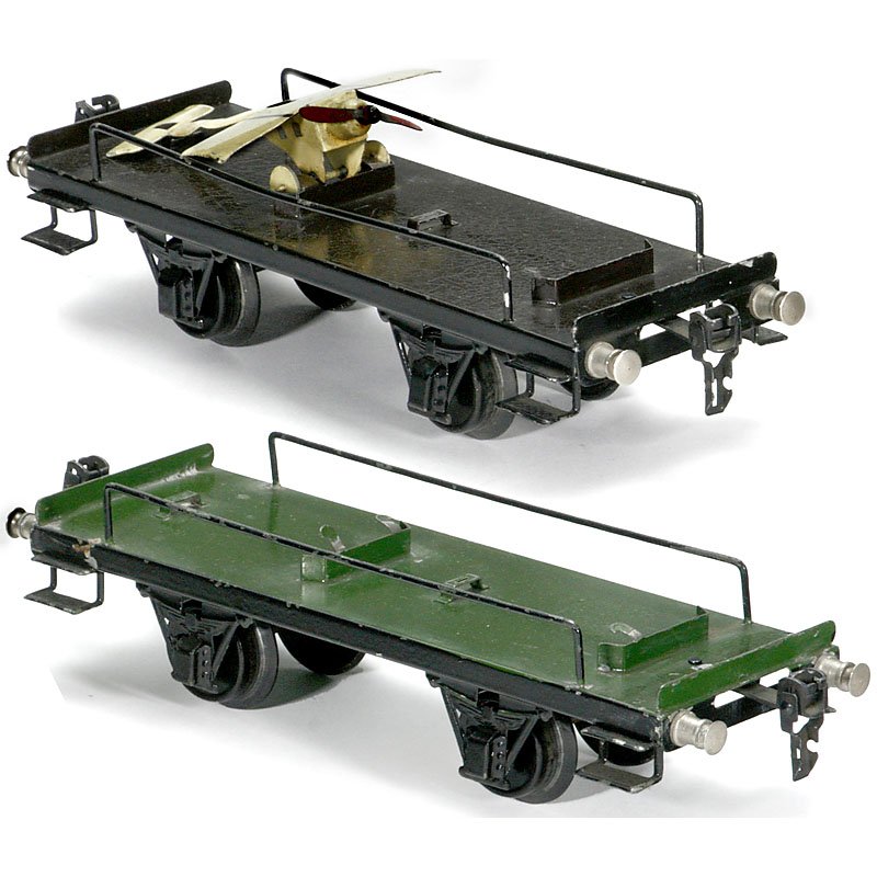 2 Gauge I Aeroplane Transportation Trucks by Märklin: 2 Gauge I Aeroplane Transportation Trucks by Märklin No. 1996/1, c. 1935 Hand-painted tin, length 9 ½ in., with 1 aeroplane (Etrich Taube model). 2 Flugzeugwagen mit 1 Flugzeug "Märklin" Nr. 1996/1