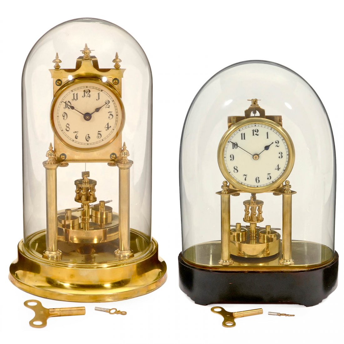 2 German Torsion Pendulum Clocks: 2 German Torsion Pendulum Clocks 1) Jahresuhrenfabrik in Triberg, Black Forest, height 12 ¼ in., c. 1912. – And: 2) Badische Uhrenfabrik, height 11 2/5 in., c. 1920. – Under glass domes, with k
