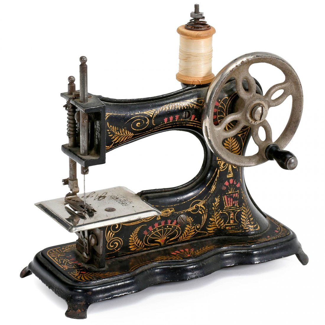 Toy Sewing Machine, c. 1930: Toy Sewing Machine, c. 1930 Unmarked, Germany, attractively decorated, cast-iron, handcranked, length 7 in., working. Kindernähmaschine, um 1930 Unbezeichnet, D.R.G.M. Nr. 205579, Gußeisen, Handkurb