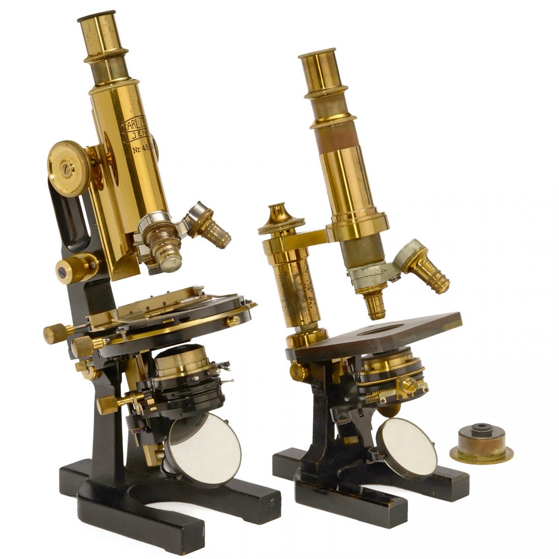 2 Microscopes by Carl Zeiss: 2 Microscopes by Carl Zeiss Carl Zeiss, Jena. 1) No. 18705, brass with black base, 2 signed lenses, 1 ocular (2), two-lens turret, coarse and fine adjustment, condenser, tilting tripod, height 13 in.,