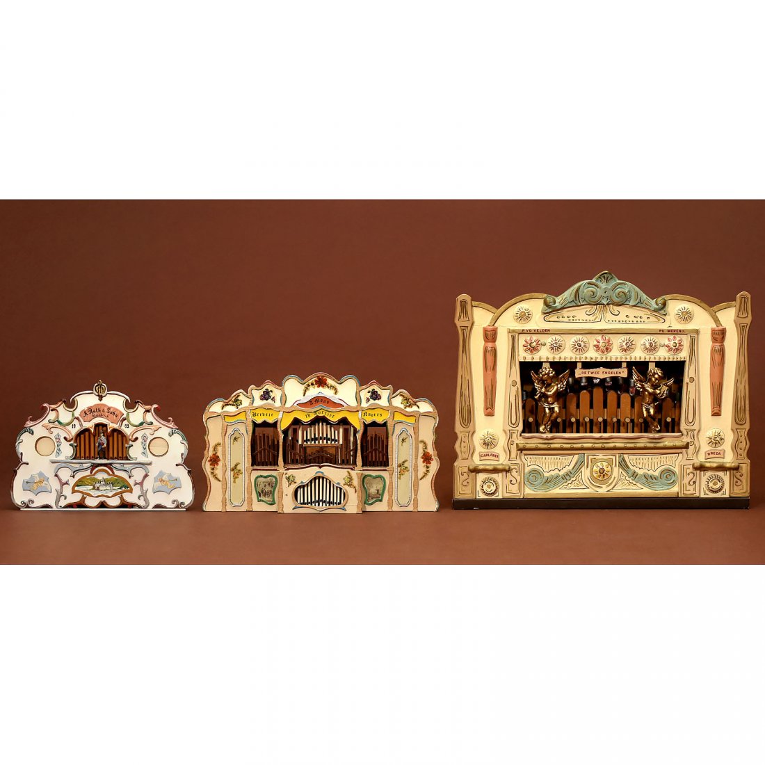 3 Models of Fairground Organs: 3 Models of Fairground Organs Hand-painted wood, partly with decals, marked "A. Ruth & Sohn, Waldkirch", "De Twe Engelen" and "Th. Mortier", widths 14 1/5 x 18 ¼ x 22 ½ in. 3 Jahrmarktorgel-Modelle