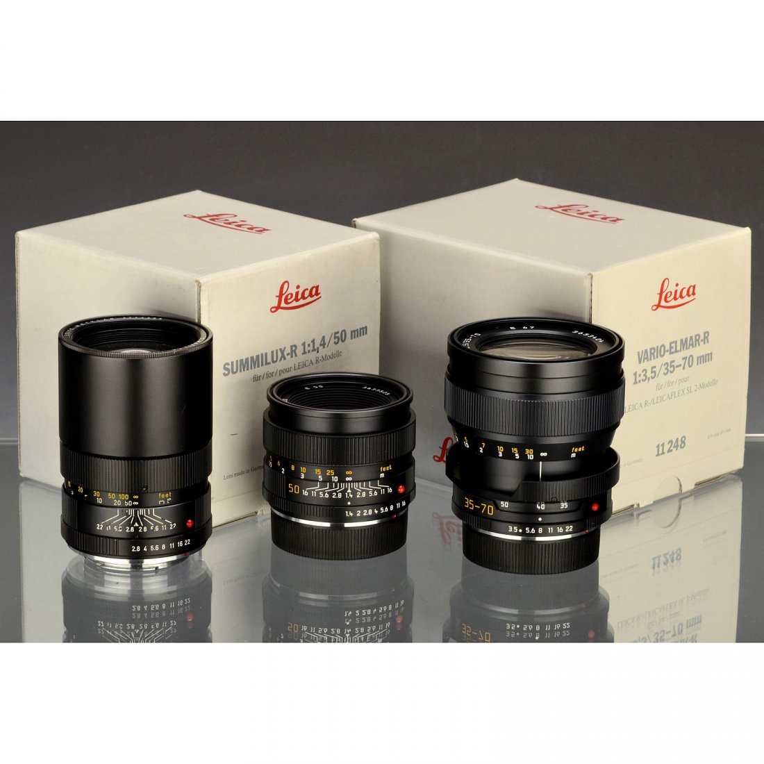 3 Leica-R Lenses: 3 Leica-R Lenses Leica, Solms. 1) Summilux-R 1,4/50 mm, 2-cam, no. 3633505, 2 caps, soft case and box, like new! (1-/1) – 2) Vario-Elmar-R 3,5/35–70 mm, 3-cam, no. 3653404, 2 caps, soft case, box 
