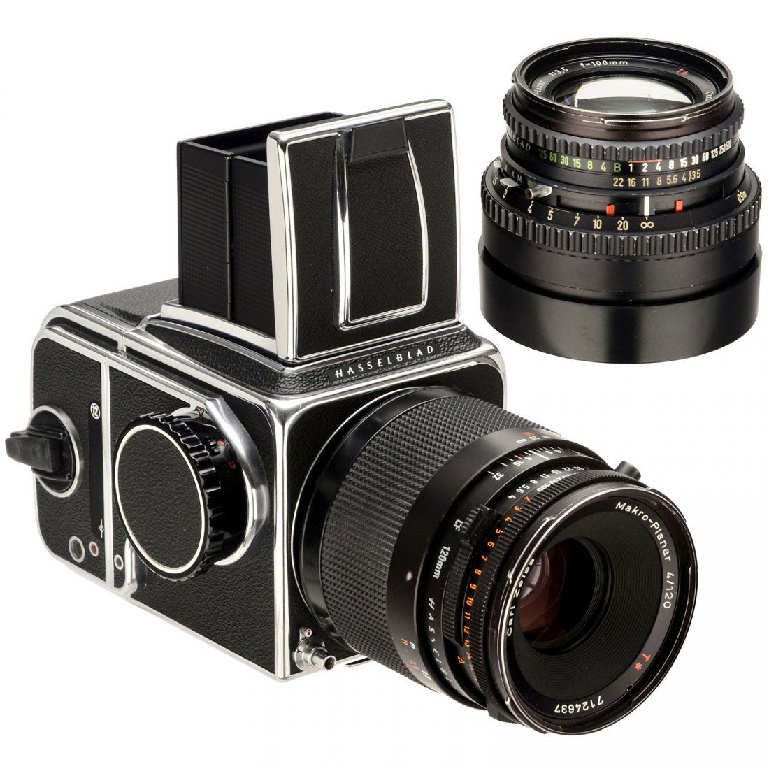 Hasselblad 500 C/M with 2 Lenses: Hasselblad 500 C/M with 2 Lenses Hasselblad, Sweden. 1) 500 C/M body, no. UC 172722, 1975, with waist-level viewfinder and magazine A12. (2/2) – 2) Planar 3,5/100 mm T, 2 caps. (3+/2) – And: 3) Ma