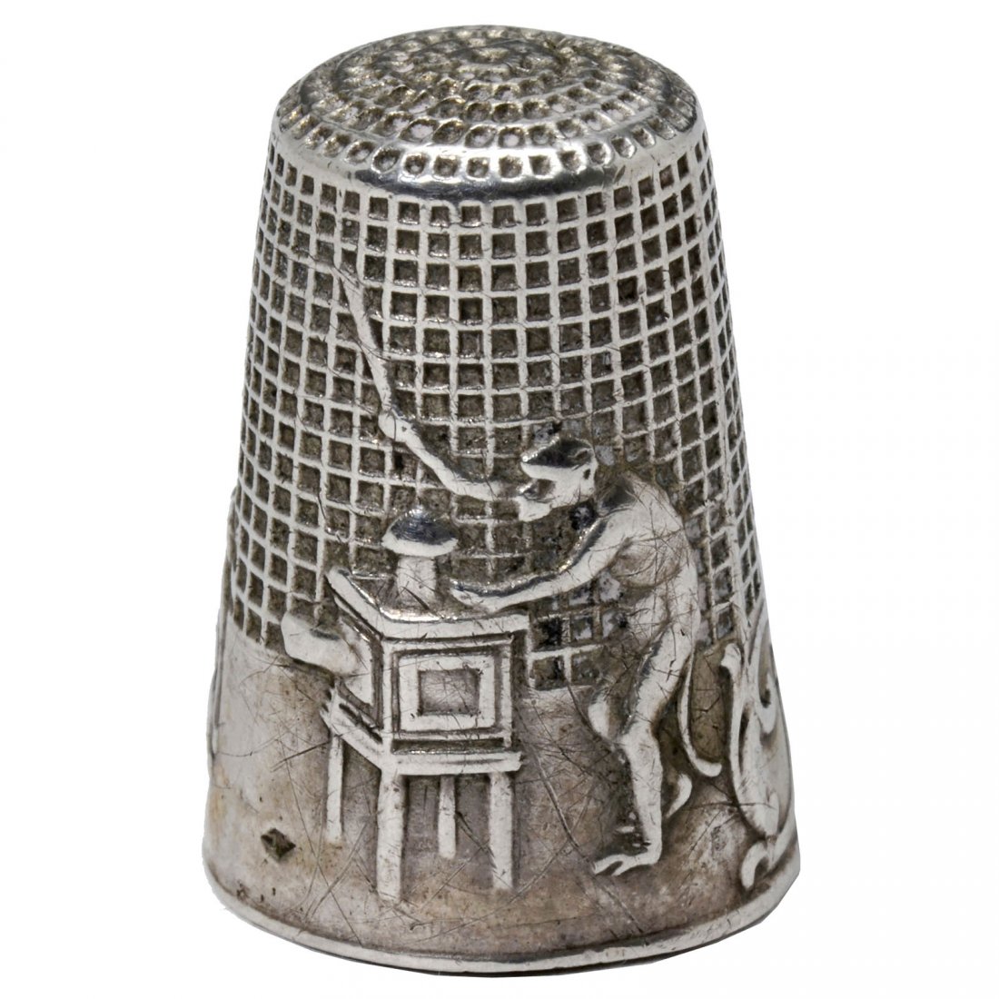 Silver Thimble with Magic Lantern and Monkey Motif, c.: Silver Thimble with Magic Lantern and Monkey Motif, c. 1850 With hallmarks, raised relief depicting monkey projectionist and its animal audience, a cat, a dog and a turkey, height 7/8 in. (2,3 cm). Th