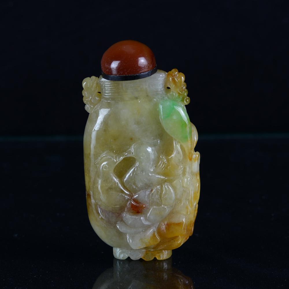 CHINESE JADEITE SNUFF BOTTLE: China, Jadeite Snuff Bottle, In Flattened Oval Form, With Detailed Carved Floral Motifs, Scalloped Rim, And Pedestal Base. H: 2 1/4 In.
