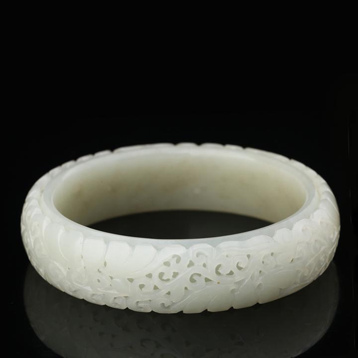 A WHITE HE TIAN JADE BANGLE CARVED (1 of 2)