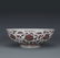 A COPPER RED BOWL WITH RED TWIGS AND PEONIES PATTERN
