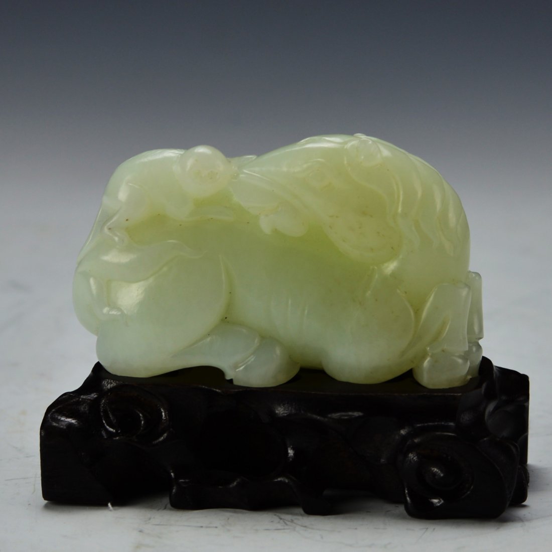 Chinese White Jade Pendant: China, whtie jade pendant, carved with monkey riding on a horse, with a wooden pedestal; L: 3 1/2 in H: 2 1/4 in