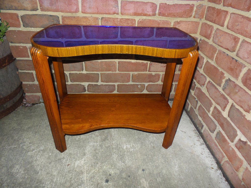 Gilbert Rhode Era mercury blue glass table plant stand: A rare vintage American art deco period Gilbert Rhode era fitted mercury blue glass top sculptural mahogany wood plant stand table. Featuring a rare art deco stream line with wave form top. Waterfall
