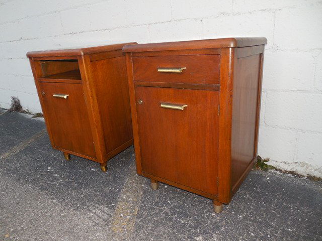Gilbert Rhode era art deco walnut wood cabinet stands: A pair of Gilbert Rhode's era American art deco period walnut wood cabinet stands. Featuring a rare art deco period stream line design. Beautiful American medium dark stained walnut wood veneer constr