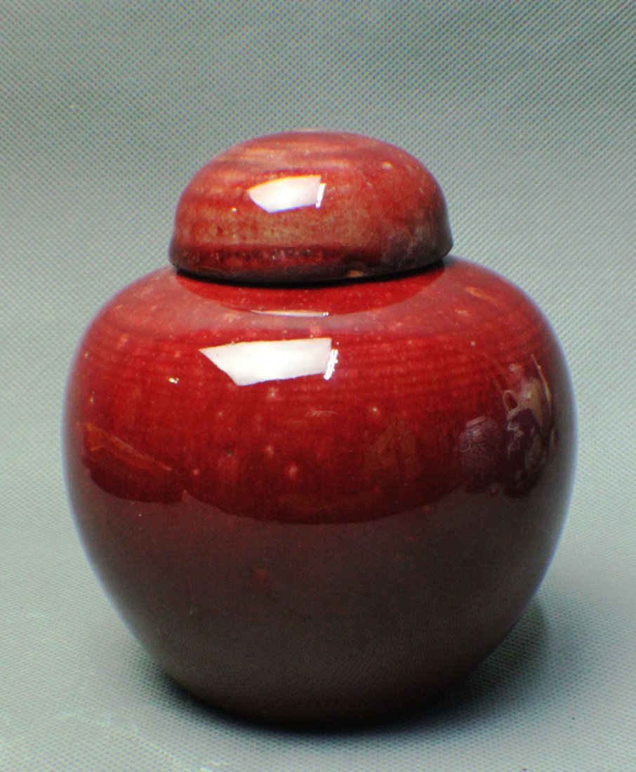 A RED GLAZED JAR WITH A COVER (1 of 4)