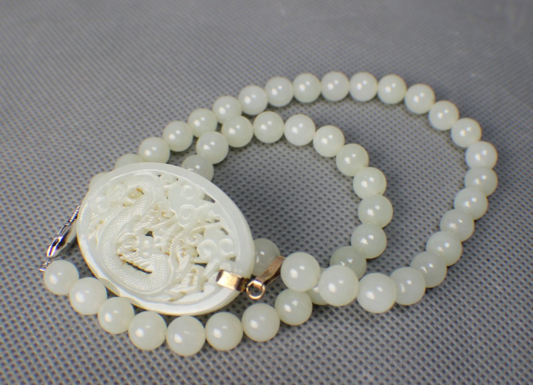 A Hetian White Suet Jade Necklace with a Pendant Carved