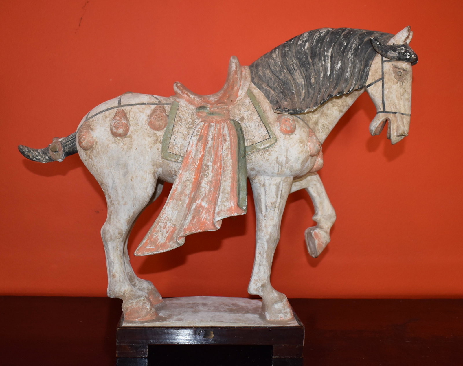 Two Chinese Earthenware Tang Horses: the fired earthenware body with polychrome decoration of wooden plinth along with an Asian brass bird. Height 16” Length 20” Width 7 ½” Smaller example Height 7 1/4"