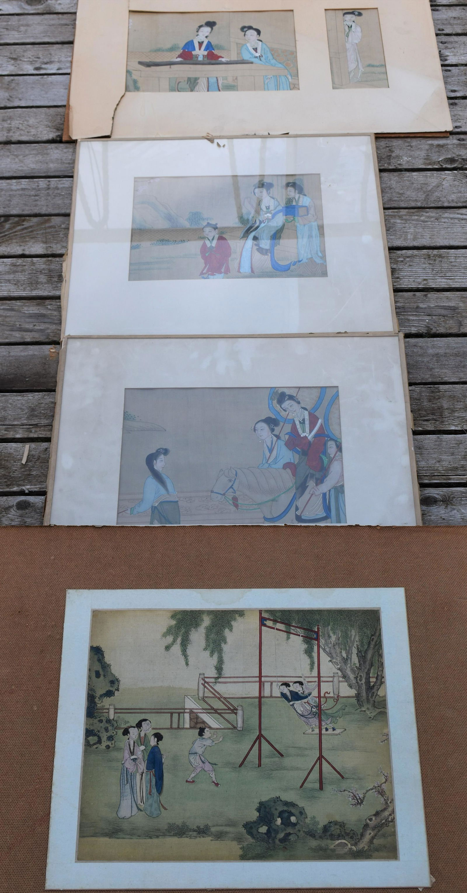 Four 19th Century Chinese Watercolors: three depicting female courtesans, one depicting children on swing. The pair Sight: 9 ½” x 12 ½” one mounted on masonite Sight 13” x 15” and one with two panel mat.