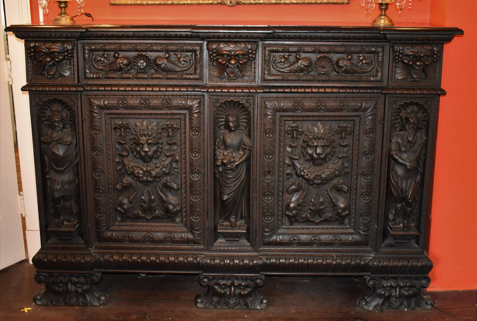 Exceptional Italian Renaissance Style Walnut Sideboard: profusely carved with figures, dolphins, sea shells, and griffins. Height 51 ½” Width 73 ½” Depth 21 ½”