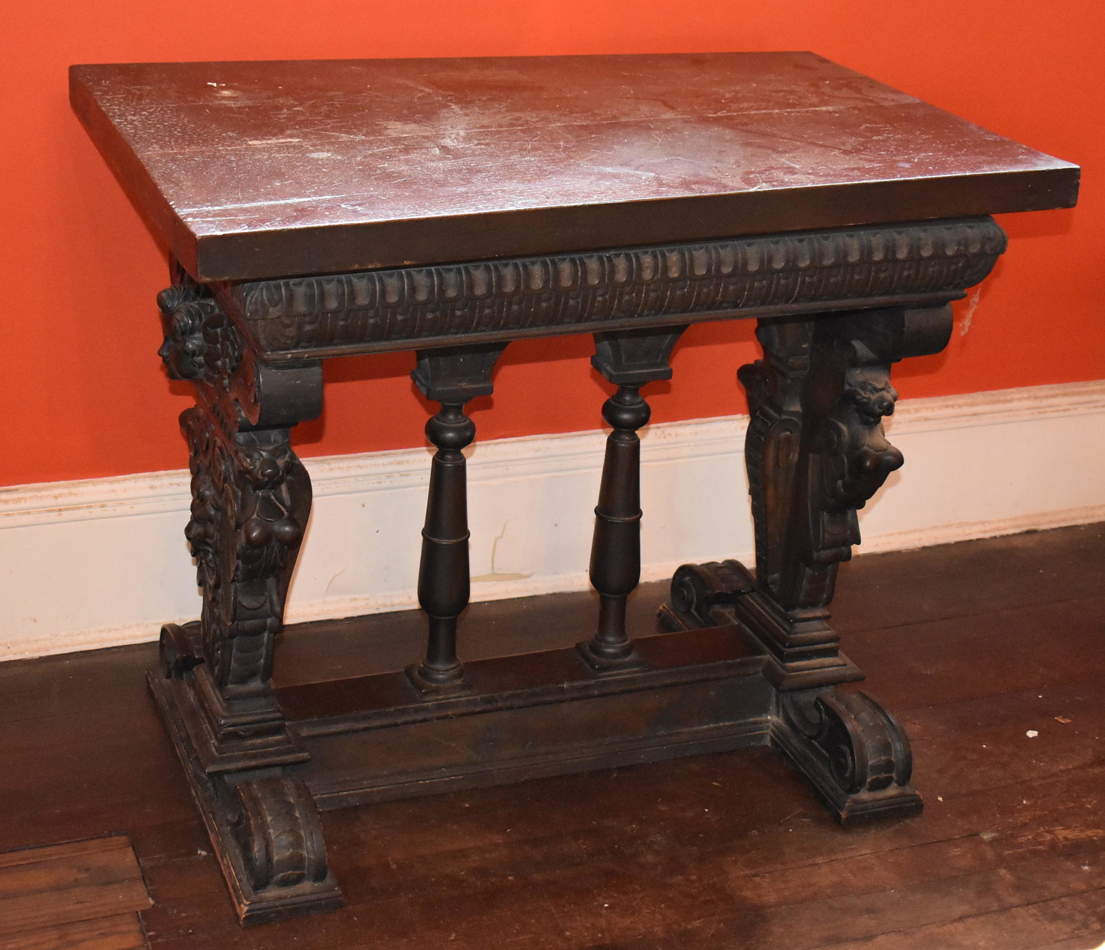 Antique Italian Renaissance Design Walnut Hall Table: having thick rectangular top above carved frieze set atop ornate winged cherub and griffen carved ends resting on scroll feet connected by stretcher with two turned columns. Height 29Â” Width 34 &f